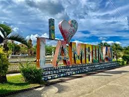 The colorful LAMBUNAO sign monument with the heart sculpture in the plaza
